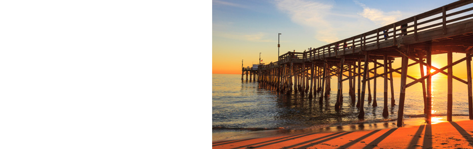 Newport Beach Pier with water underneath at sunset